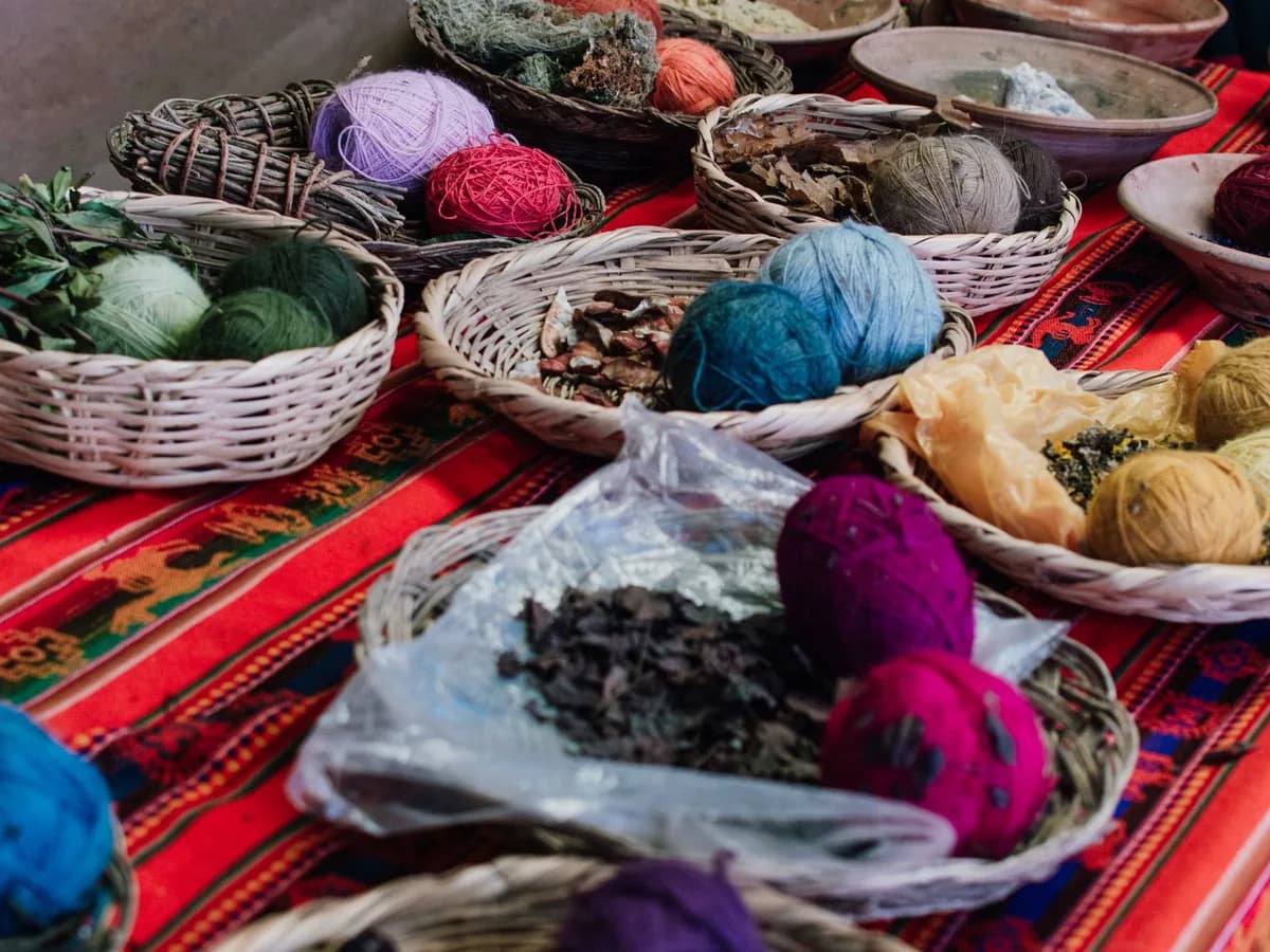 Traditional yarns, natural dyes, and woven textiles at a market in Cusco, Peru.